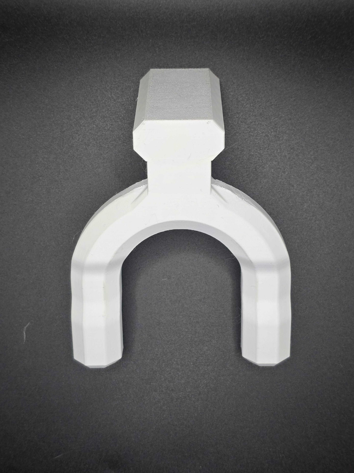 Minimalist white guitar wall mount bracket from Tarbon Designs