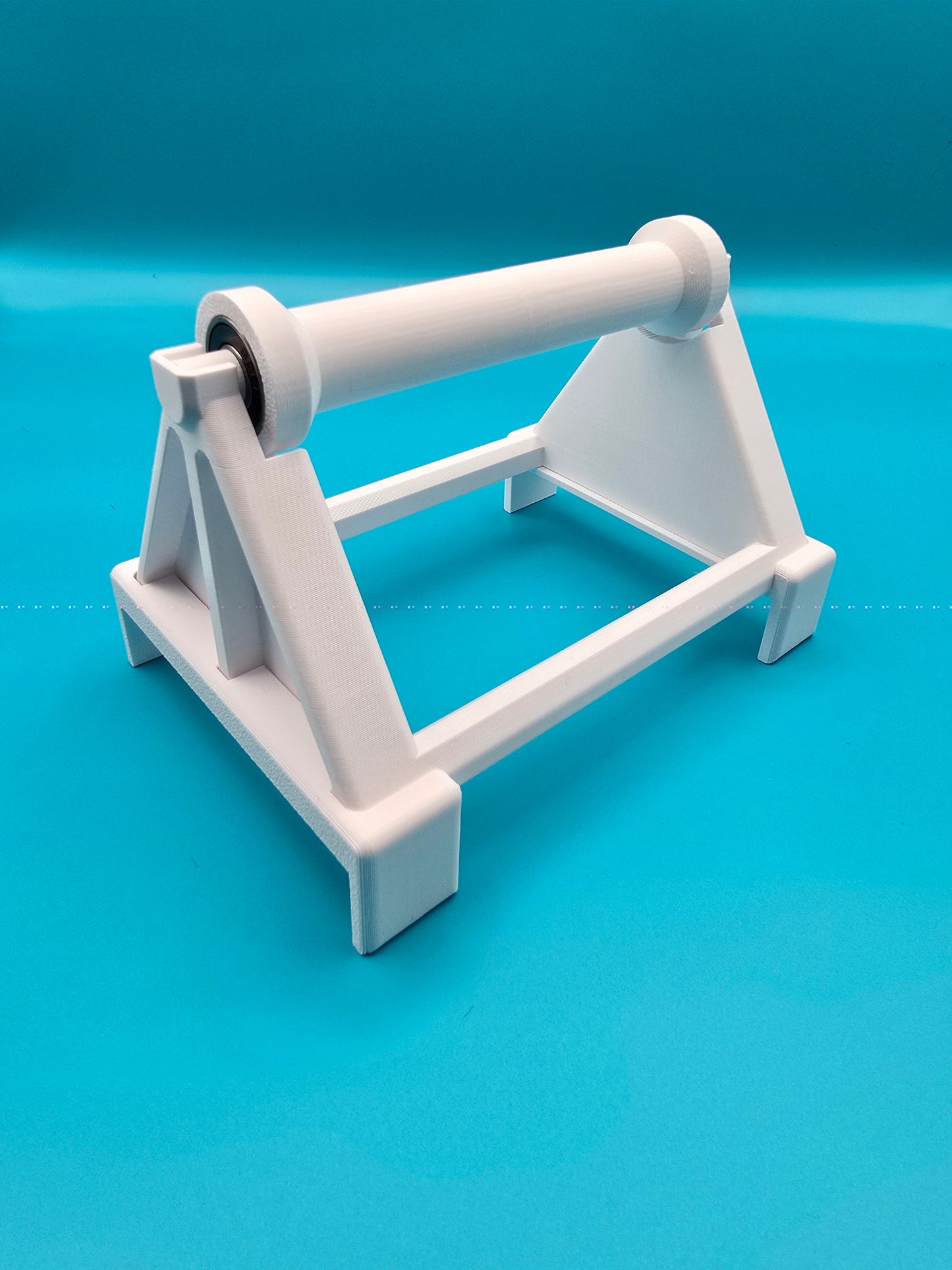 White 3D printed spool stand for desktop shipping label printers