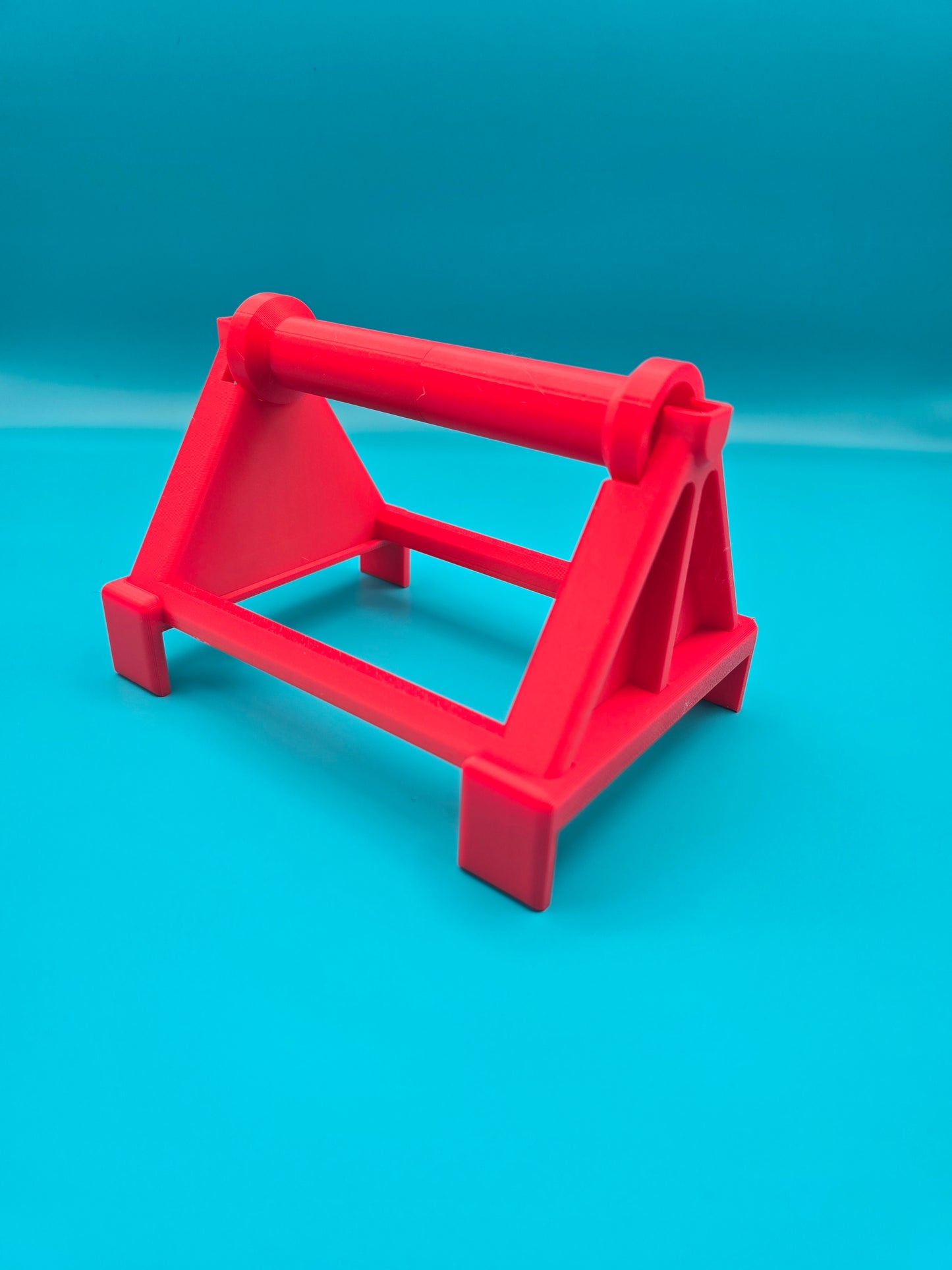 Vibrant red 3D printed thermal printer roll spool stand for desktop shipping label printers
