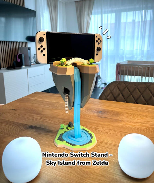 Nintendo Switch Stand - Inspired by the floating Islands from "Legend of Zelda"

This image depicts a Nintendo Switch console stand designed to resemble the iconic floating islands from the "The Legend of Zelda" video game series. The stand features a cloud-like platform supporting the Nintendo Switch console, with a bright blue stem connecting it to the wooden surface below. The stand's whimsical, game-inspired design complements the surrounding home decor.
