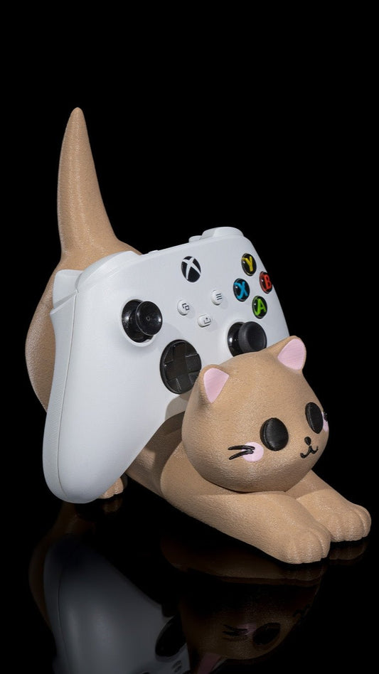 White and gray gaming controller and stuffed animal toy on black background